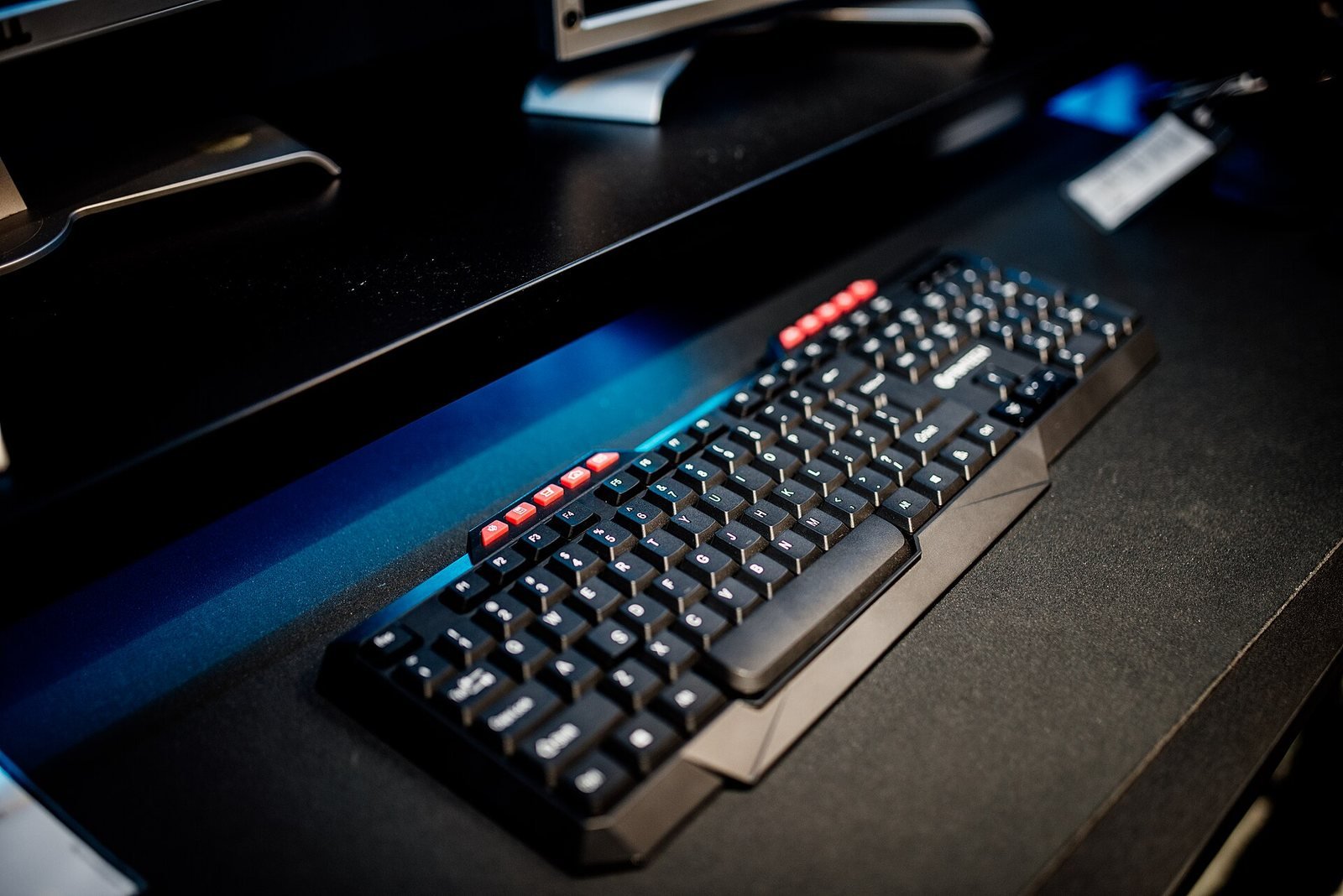 A keyboard on a dark desk